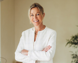Woman in white jacket smiling
