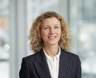 Woman in suit smiling